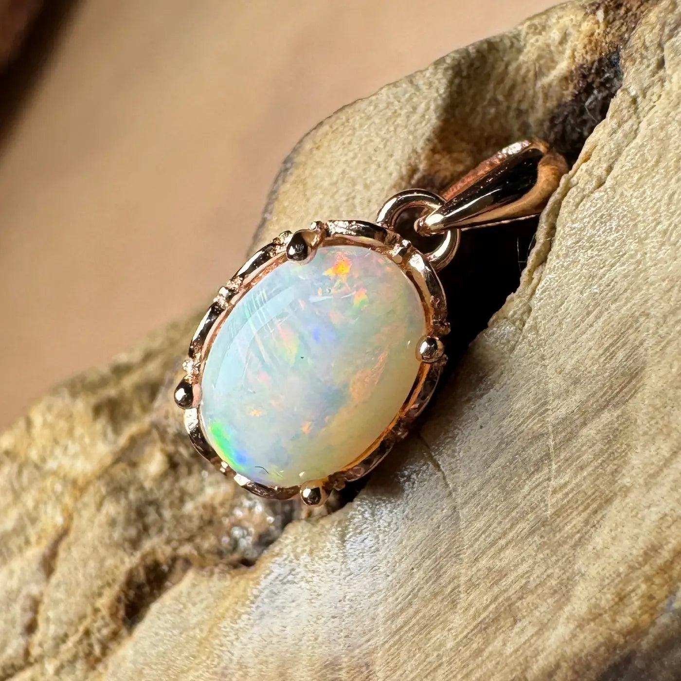 Oval opal pendant with rose gold setting in the Larapinta Flame handcrafted jewelry piece