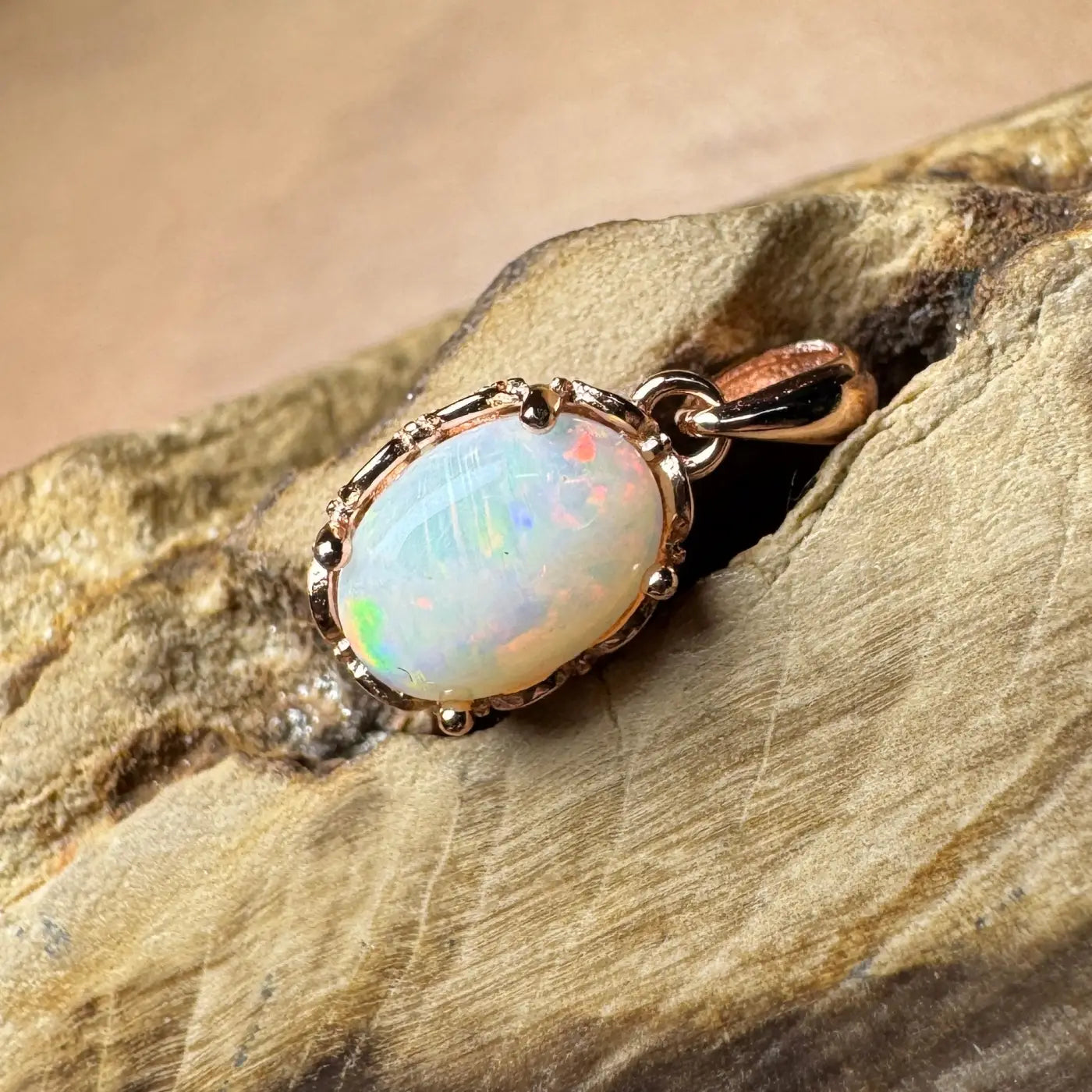 Oval opal pendant with rose gold setting in handcrafted Larapinta Flame jewelry design