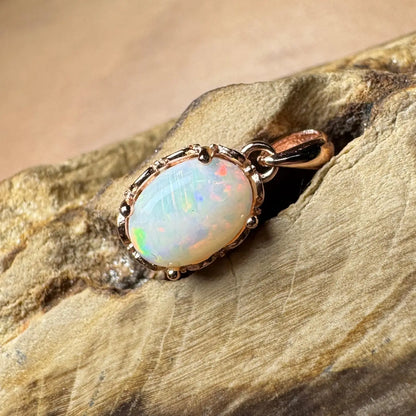 Oval opal pendant with rose gold setting in handcrafted Larapinta Flame jewelry design