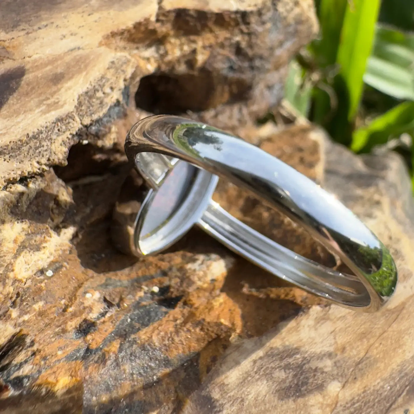 Shiny silver Lightning Loop ring with a light-colored Lightning Ridge Opal gemstone