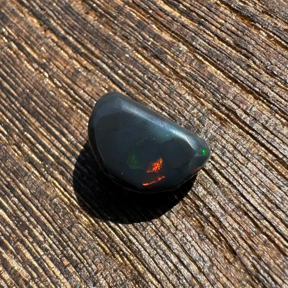Polished Lightning Ridge Black Opal 1.4 carats with red and green flashes