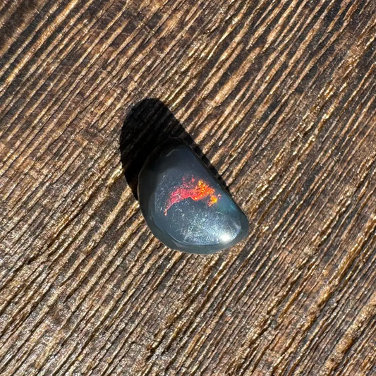 Polished Lightning Ridge Black Opal 1.4 carats with vibrant red fire and hand-cut craftsmanship