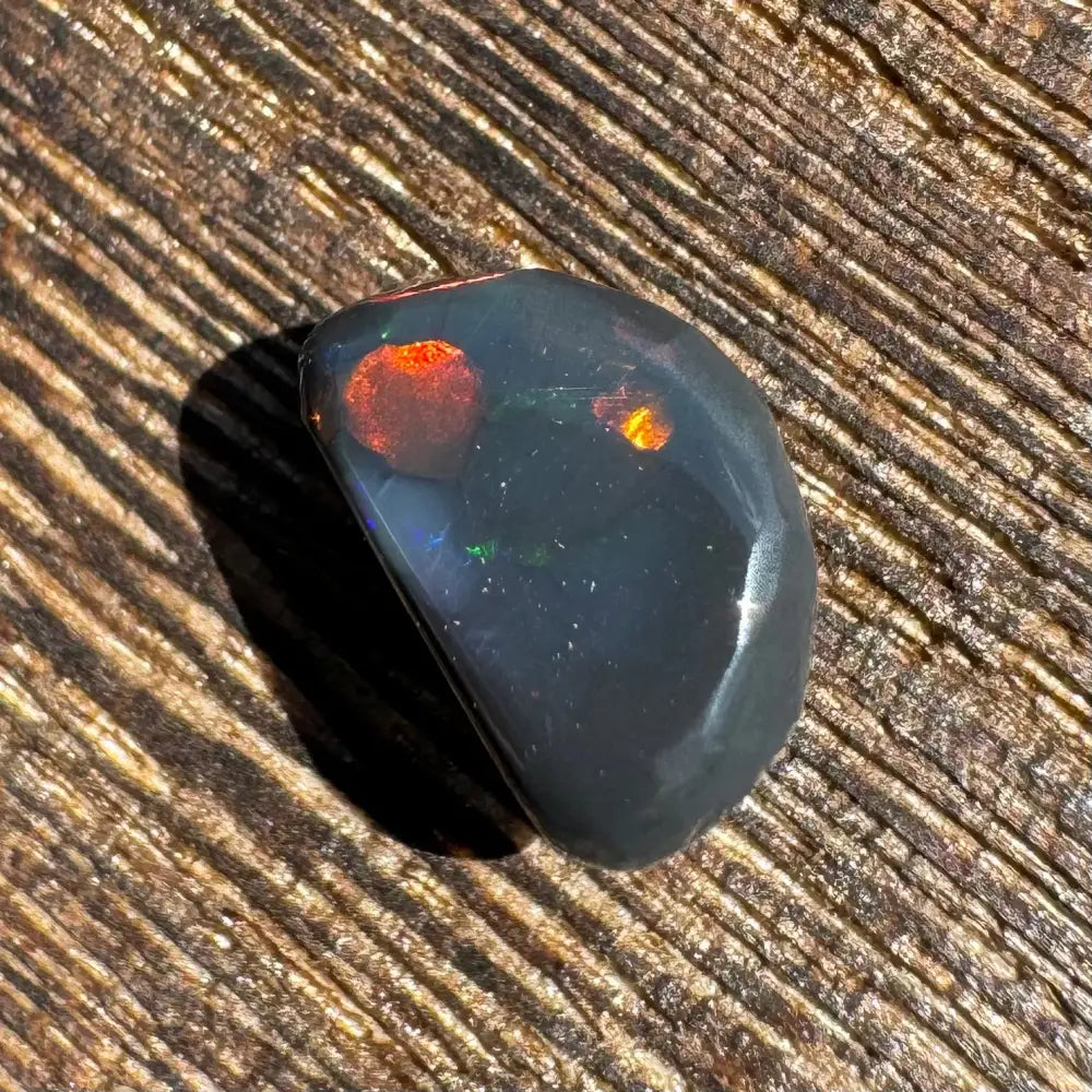 Polished Lightning Ridge Black Opal 1.4 carats with striking red and orange flashes