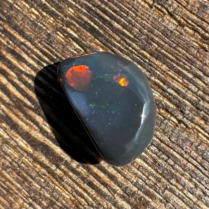 Polished Lightning Ridge Black Opal 1.4 carats with striking red and orange flashes