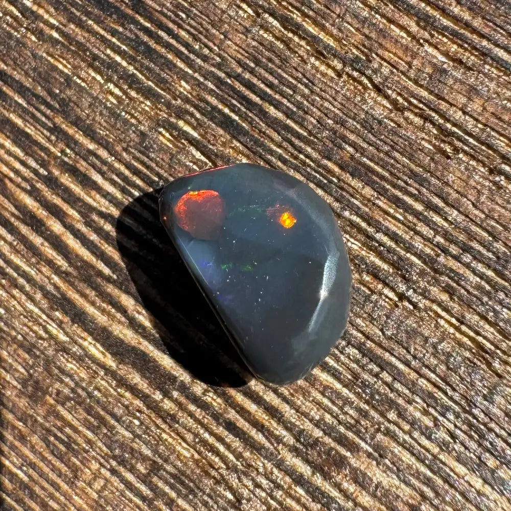 Polished Lightning Ridge Black Opal 1.4 Carat with red and orange flashes