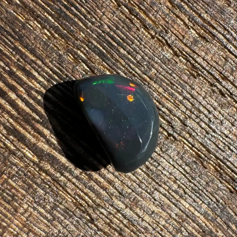 Polished Lightning Ridge Black Opal with vibrant colorful flashes, 1.4carat hand-cut gemstone