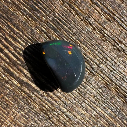 Polished Lightning Ridge Black Opal with vibrant colorful flashes, 1.4carat hand-cut gemstone