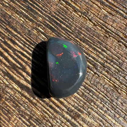 Polished Lightning Ridge Black Opal 1.4 Carat with red and green play-of-color