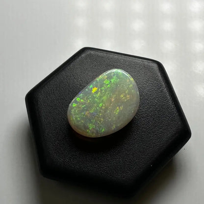 Iridescent Lightning Ridge Opal gemstone displayed in the 2.4 carat solid hand-cut product