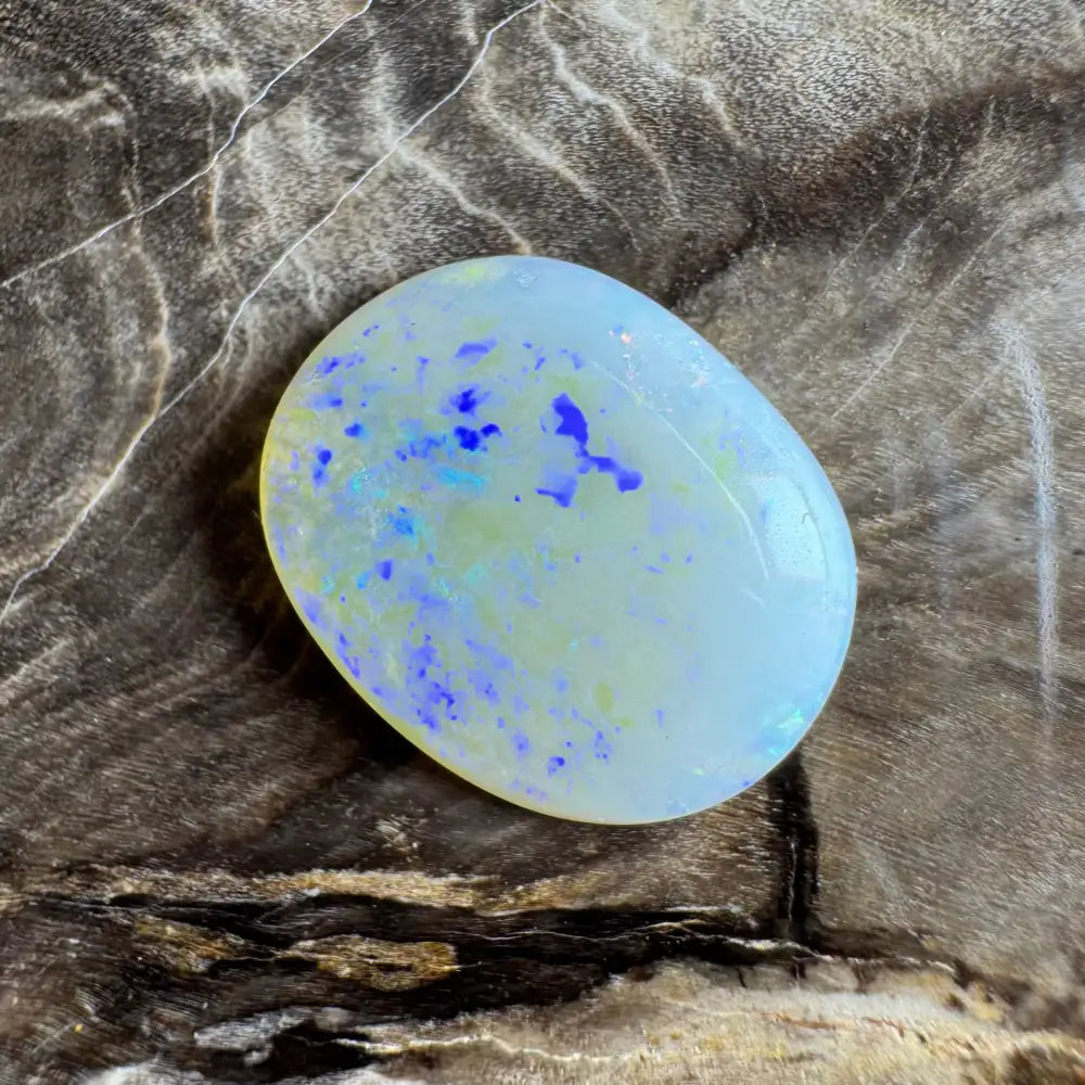 Oval Lightning Ridge Opal with blue and yellow inclusions, 3.5 carats, hand-cut gemstone