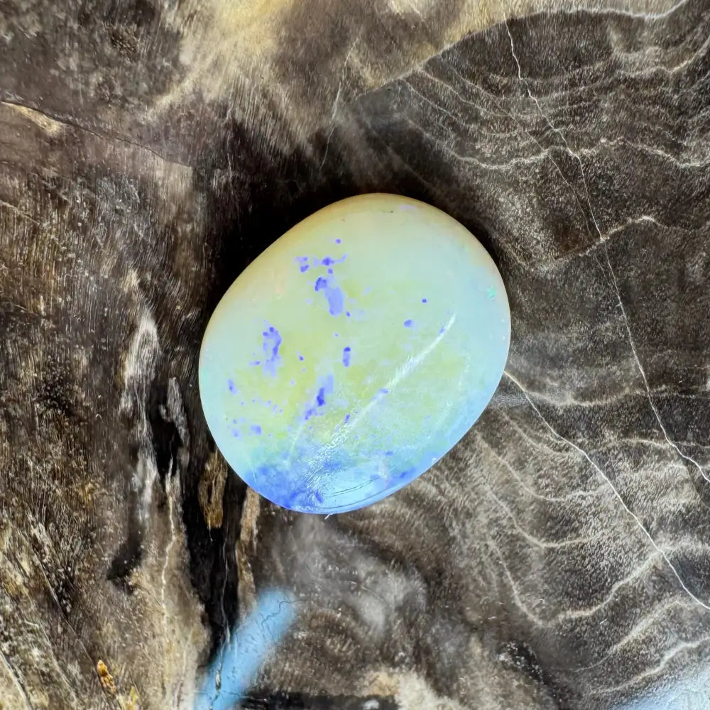 Polished Opalite stone with blue and purple inclusions in the Lightning Ridge Opal 3.5 carat solid hand-cut product