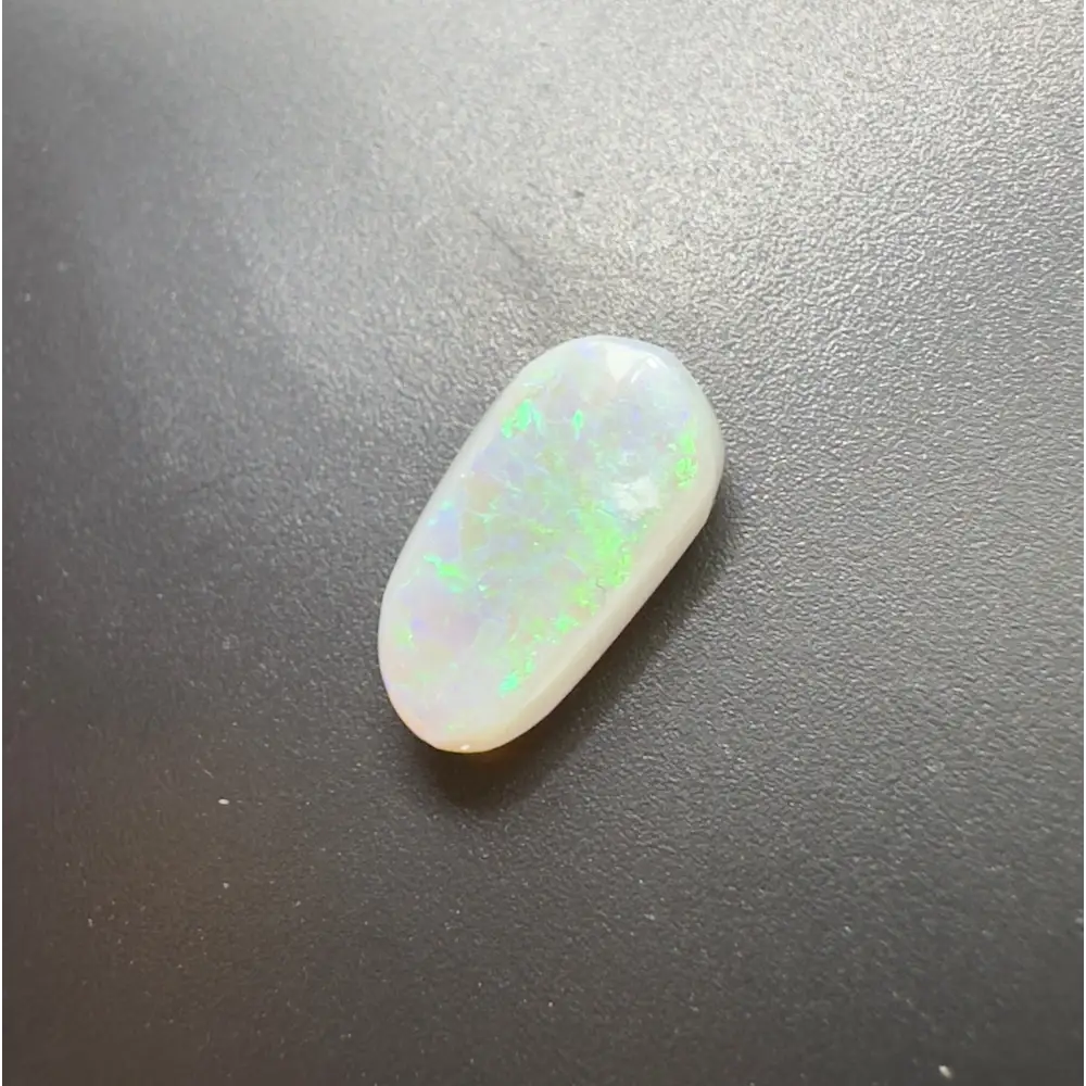 Elongated white opal with green and blue play-of-color in Lightning Ridge Semi Black Opal 1.2carat