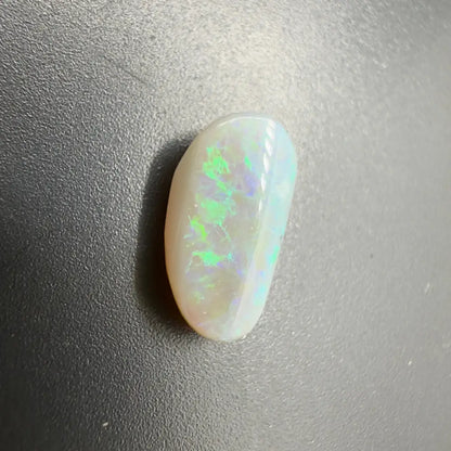 Polished white opal with striking green and blue play-of-color in Lightning Ridge Semi Black Opal 1.2carat