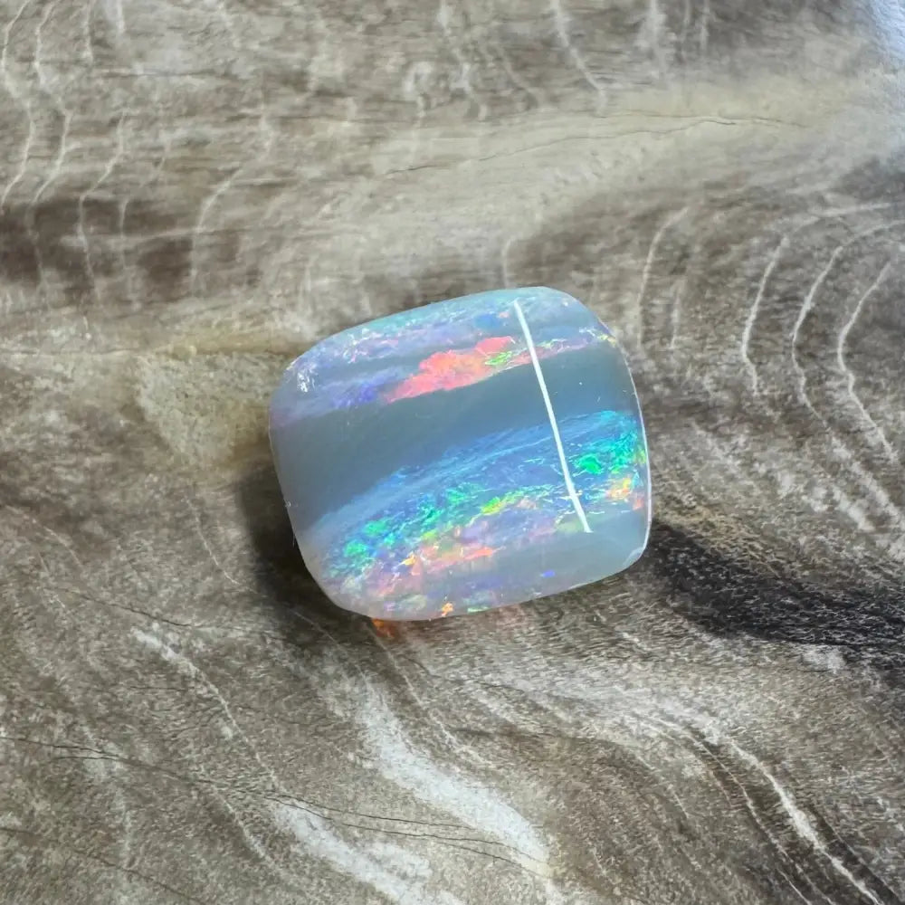 Iridescent Lightning Ridge Semi Black Opal with white line showcasing vibrant colors and luster