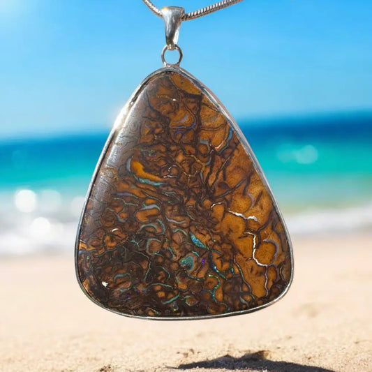 Triangular Queensland Boulder Opal pendant on silver chain from Ocean and Earth collection