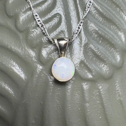 Silver necklace with opal pendant.