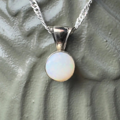 Silver necklace with opal pendant.