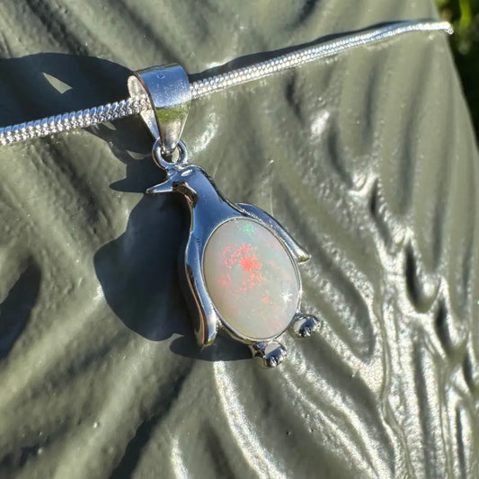 Silver penguin pendant featuring a 1 carat Coober Pedy opal in a handcrafted sterling silver necklace