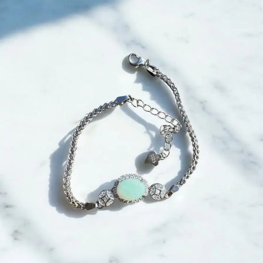 Silver bracelet featuring a 1.4-carat Coober Pedy Opal center stone and cubic zirconia accents