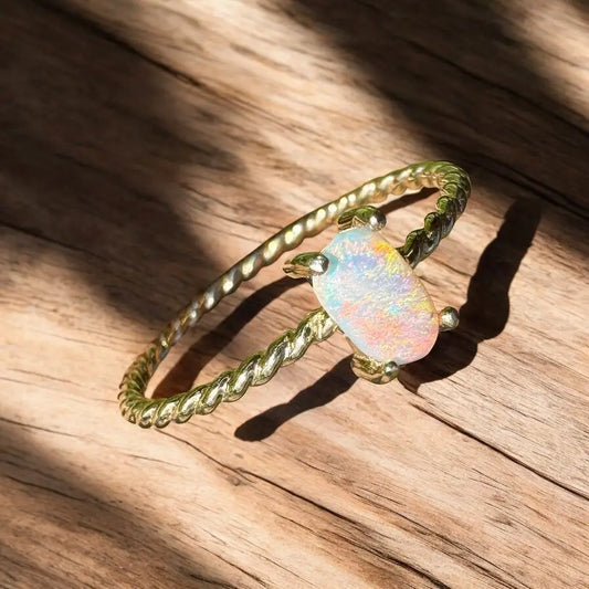 Gold ring with a stunning 0.5-carat Coober Pedy opal gemstone in yellow gold setting