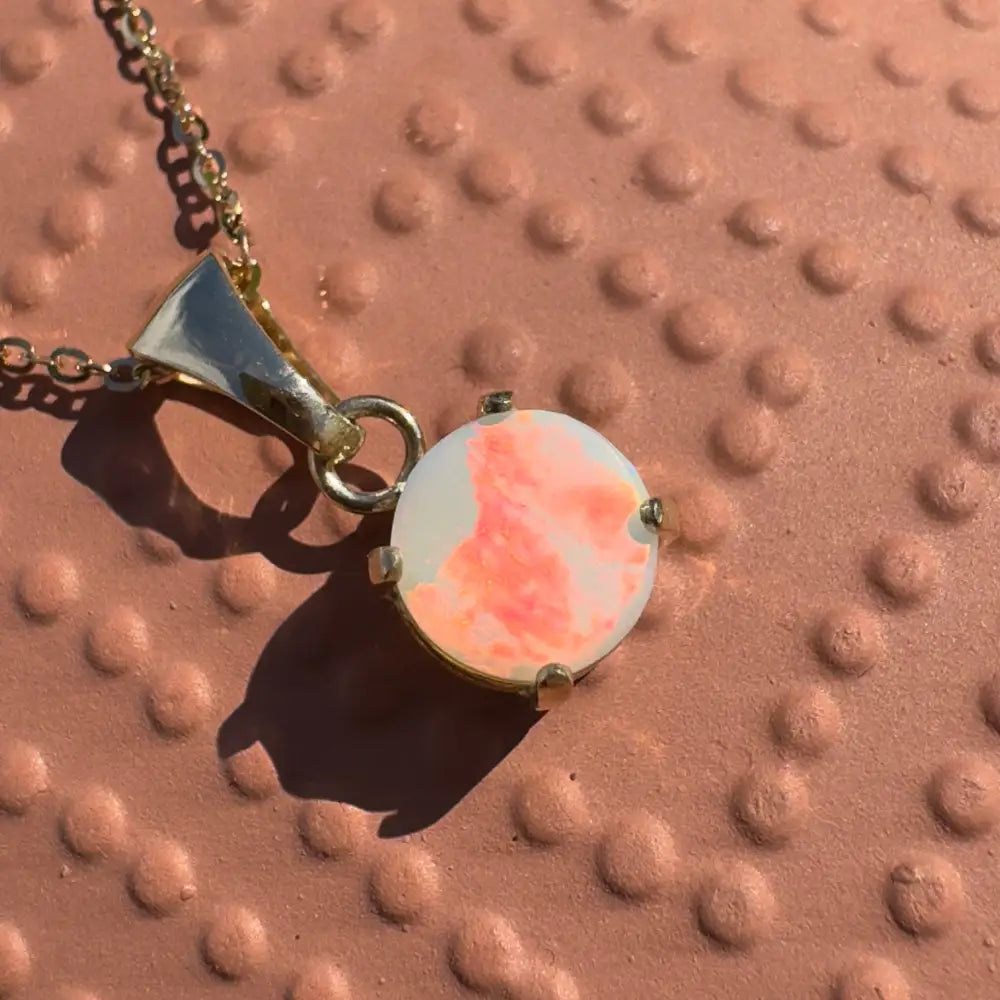 Gold chain necklace with round Lightning Ridge opal pendant from Red Sky at Night collection