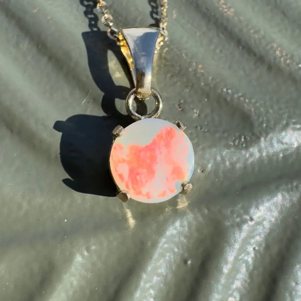 Silver necklace with a round Lightning Ridge opal pendant from Red Sky at Night collection