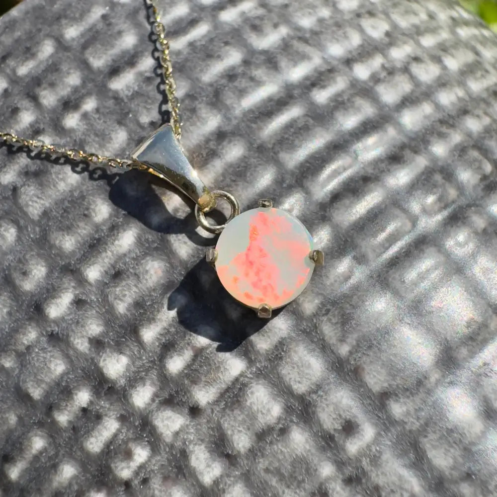 Silver necklace with a round Lightning Ridge Opal pendant from Red Sky at Night collection