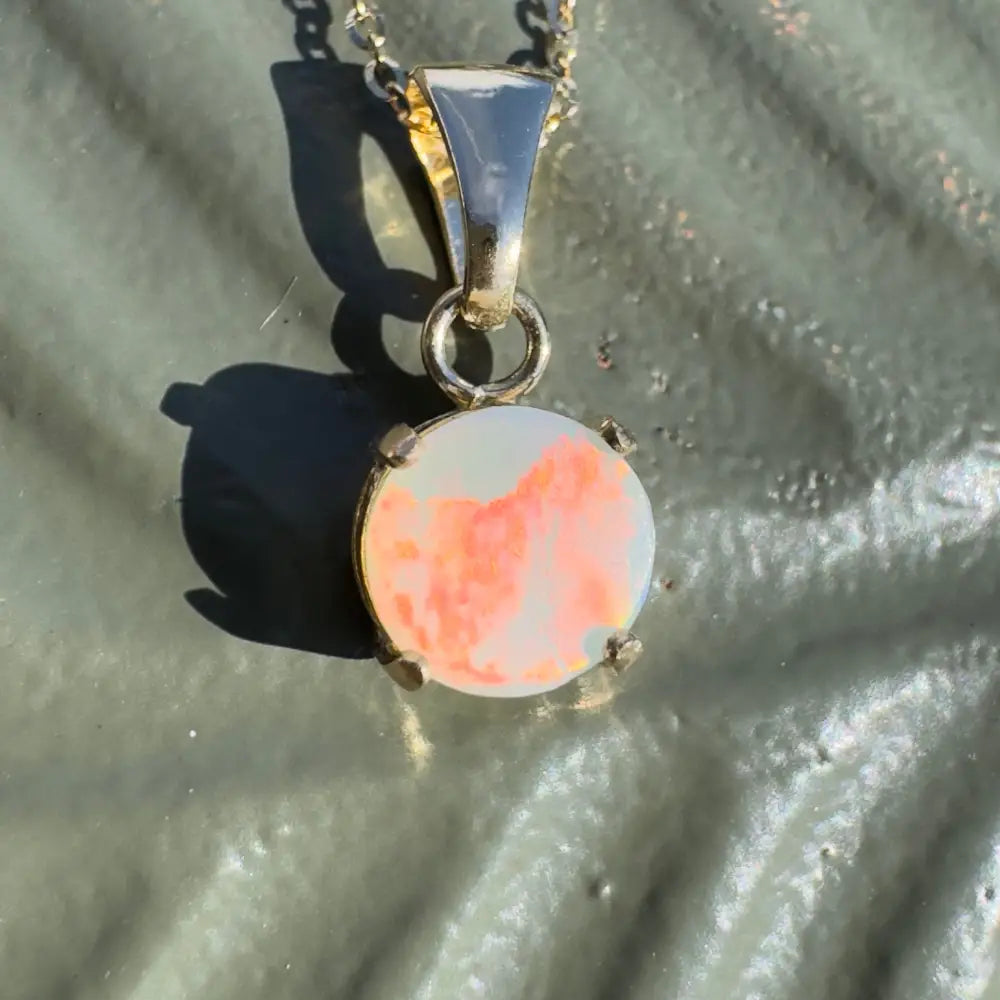 Silver pendant with round opal from Lightning Ridge featured in Red Sky at Night jewelry piece