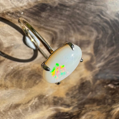 Oval opal ring with vibrant colorful flashes in handcrafted Coober Pedy opal and 9ct yellow gold