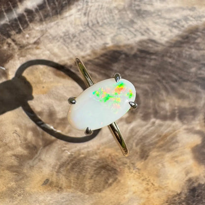 Oval opal ring with vibrant colorful flashes in handcrafted 9ct yellow gold design