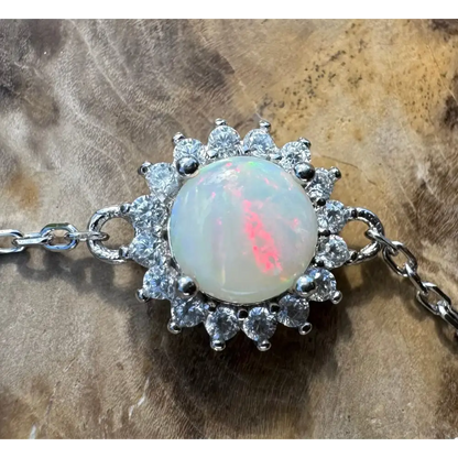 Opal gemstone bracelet with diamond halo.