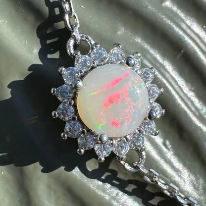 Opal pendant with diamond halo.