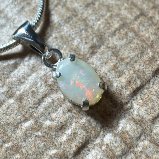 Opal pendant with silver setting from the Sunset Reds handcrafted necklace collection