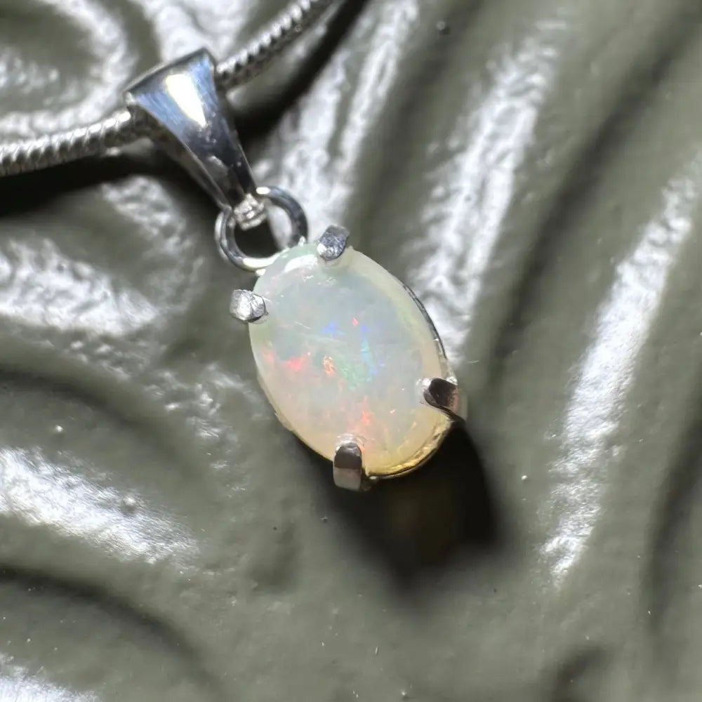Oval opal pendant with silver prongs from Sunset Reds handcrafted Coober Pedy opal necklace