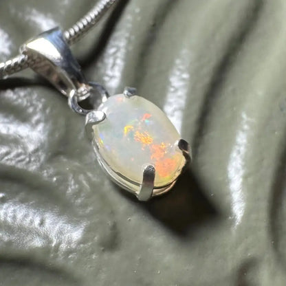 Oval opal pendant with silver setting in the Sunset Reds handcrafted sterling silver necklace