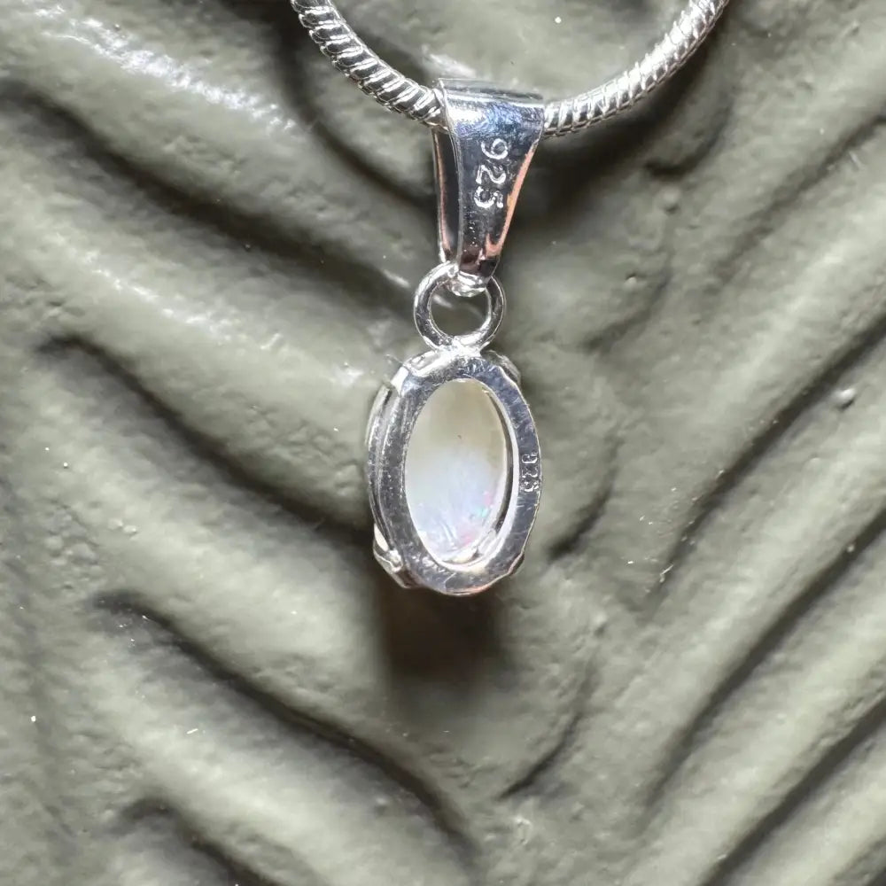 Silver pendant with oval white stone from Sunset Reds handcrafted Coober Pedy Opal necklace