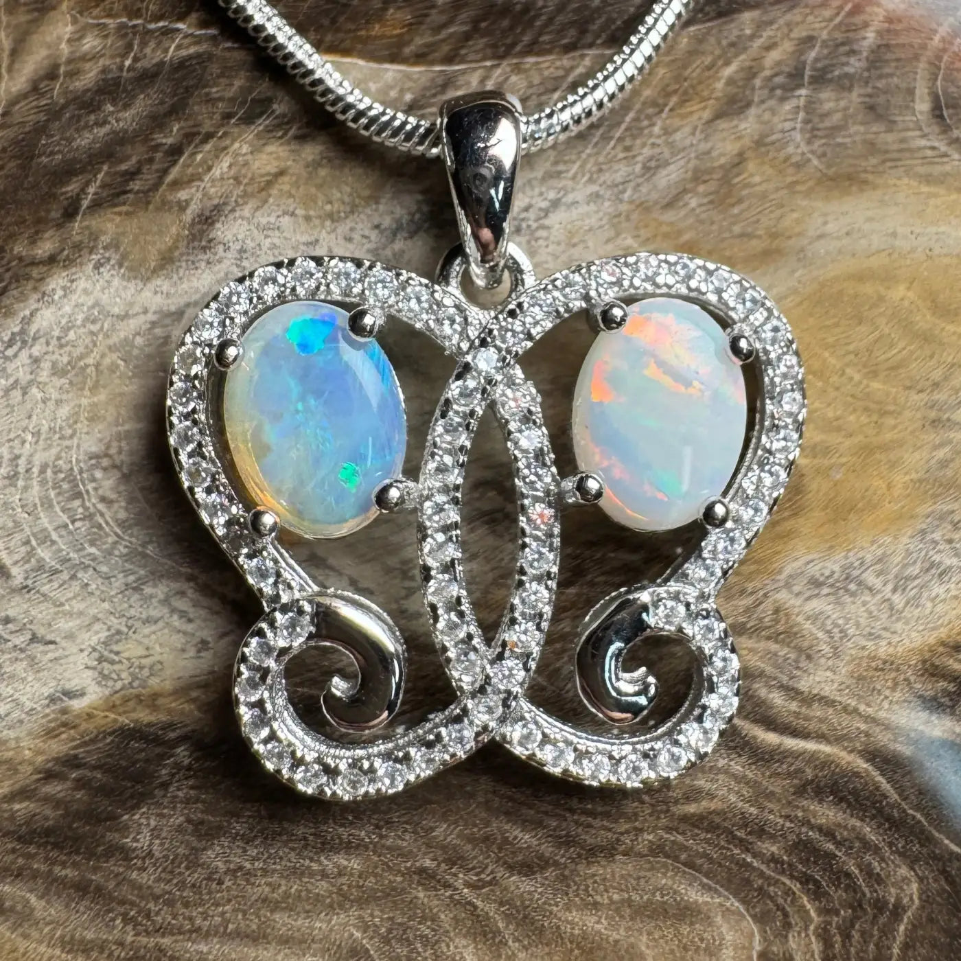 Silver opal butterfly pendant featuring Coober Pedy and Lightning Ridge opals in necklace