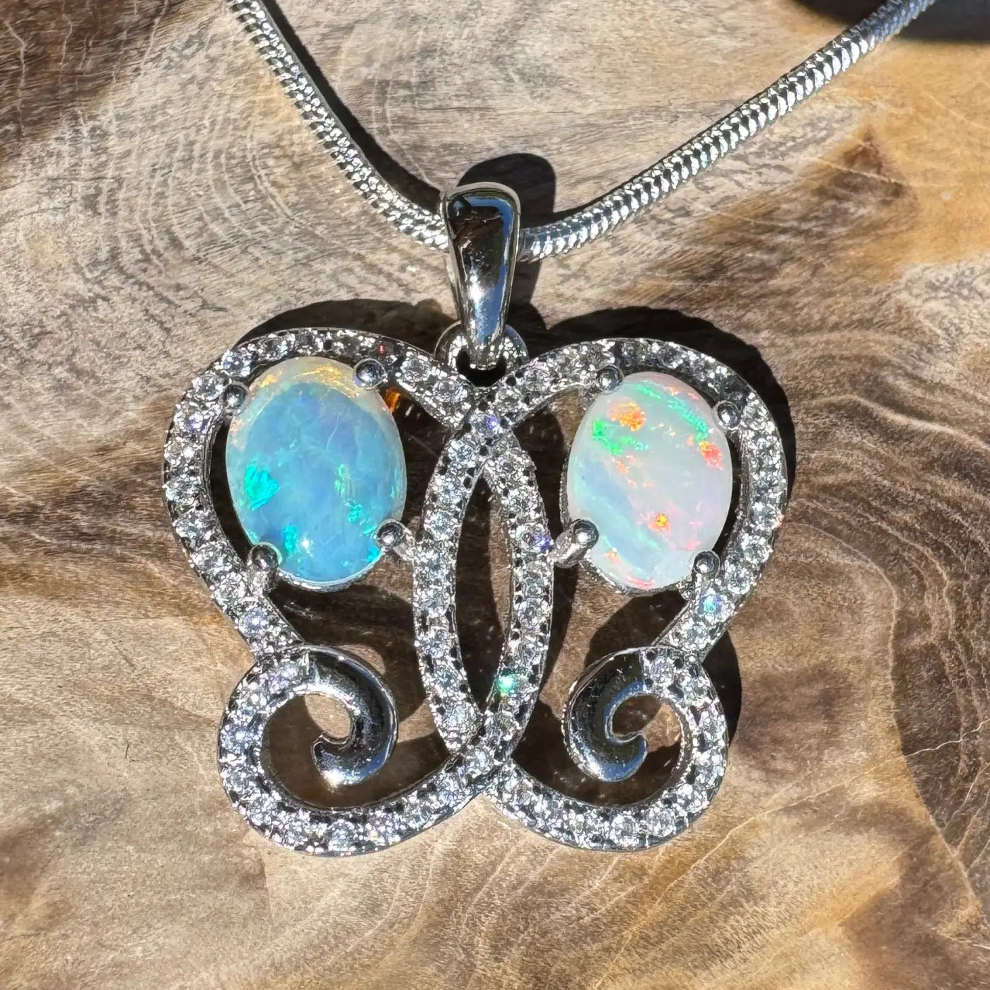 Opal butterfly pendant made of Coober Pedy and Lightning Ridge Opals with sterling silver