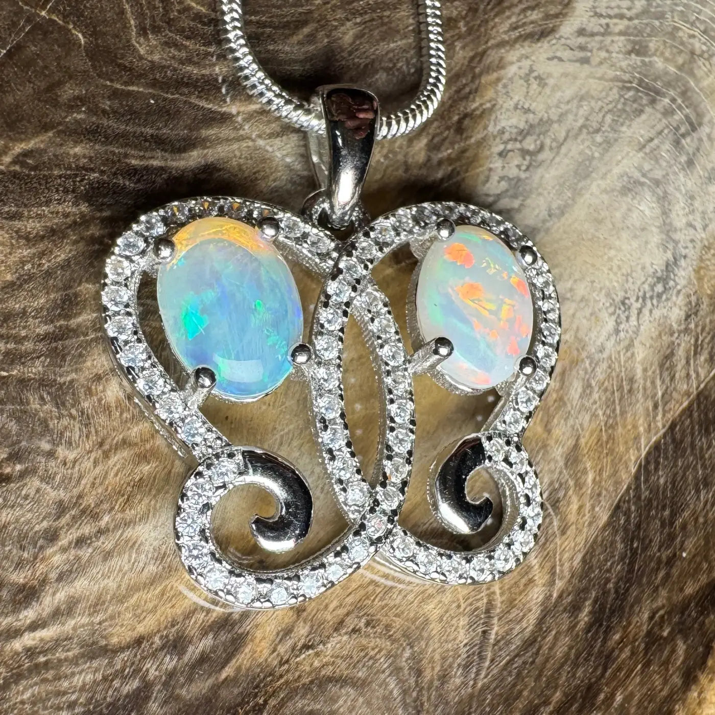 Butterfly-shaped pendant with Coober Pedy opal and cubic zirconia in sterling silver