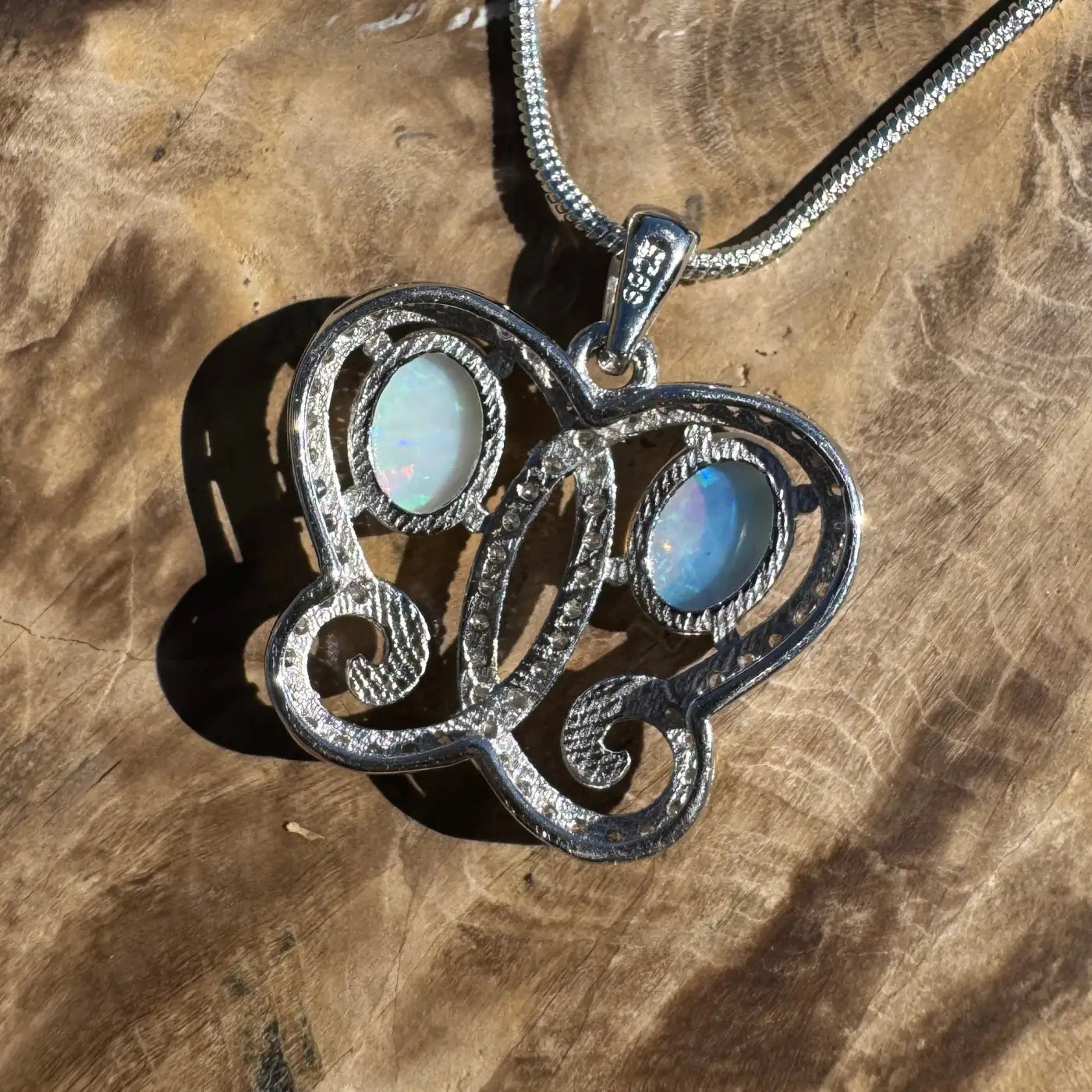 Silver opal pendant necklace featuring a handcrafted 1.2ct Coober Pedy and Lightning Ridge opal with cubic zirconia accents in sterling silver