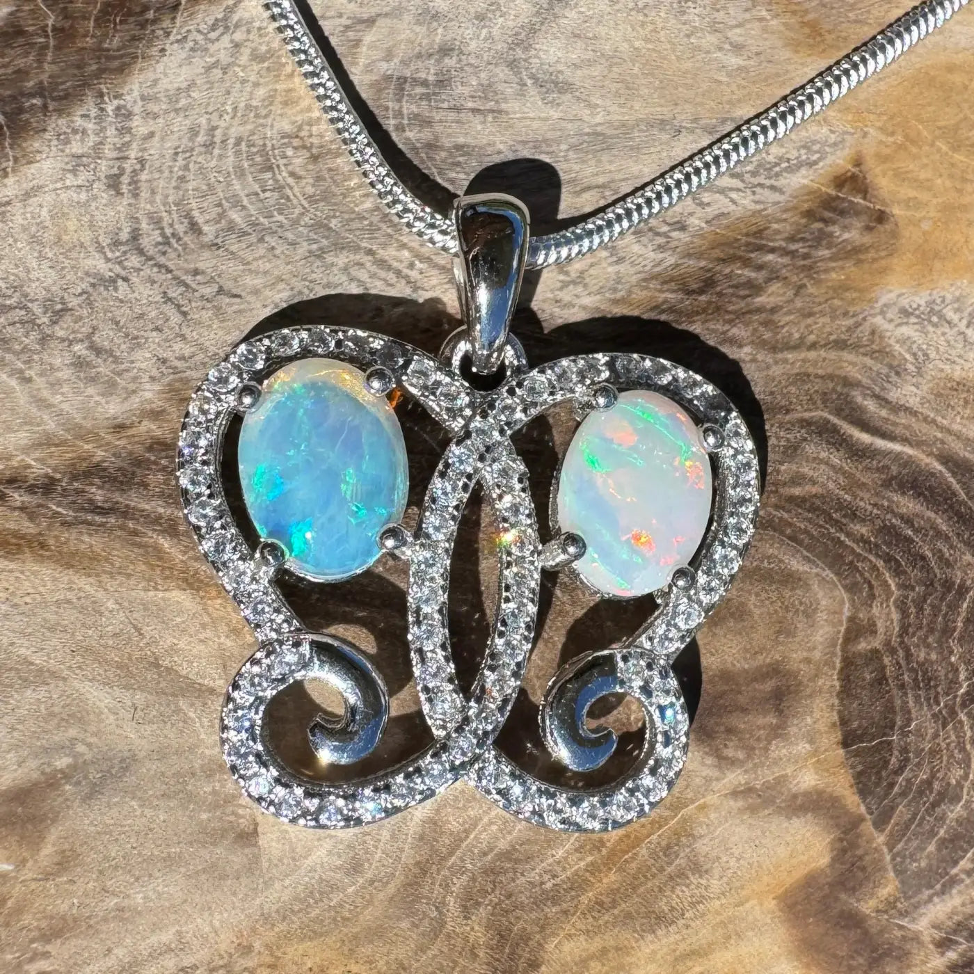 Silver butterfly pendant with 1.2ct Coober Pedy and Lightning Ridge opal gemstones