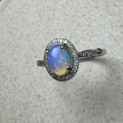 Handcrafted Wave Rock Grace ring featuring a 0.8ct Lightning Ridge Opal with diamond halo in sterling silver