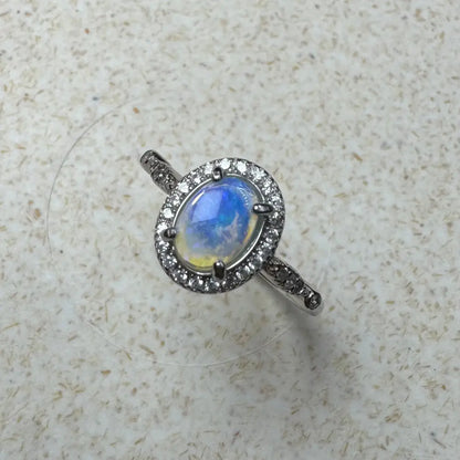 Opal ring with diamond halo featuring a 0.8ct Lightning Ridge Opal in sterling silver