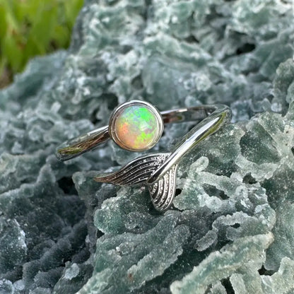 Silver sterling ring featuring a Lightning Ridge opal and mermaid tail design
