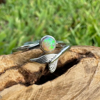 Silver ring featuring an opal and mermaid tail design from Where the Ocean meets the Outback collection