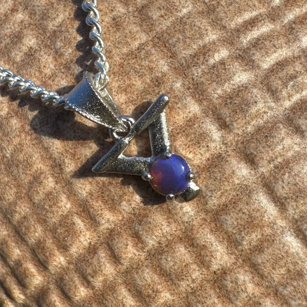 Silver pendant with a purple lightning Ridge Opal gemstone on a sterling silver necklace
